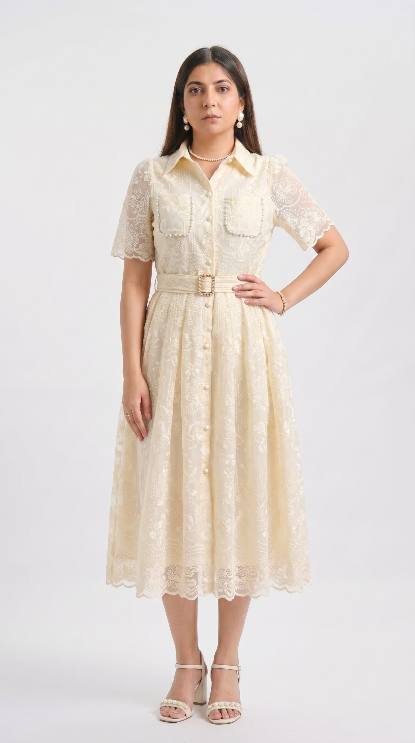 Woman wearing a beige lace dress on a white background