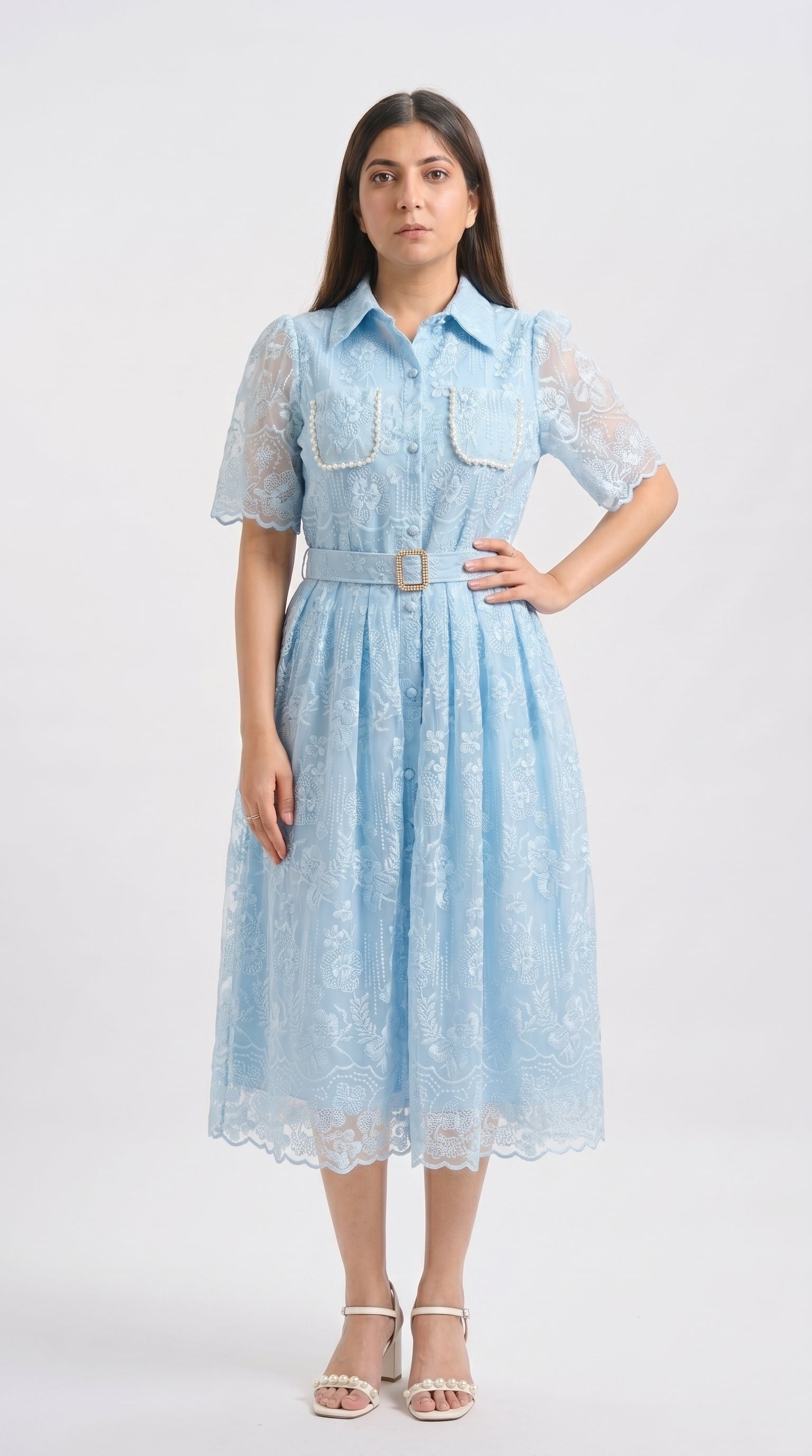 Woman wearing a light blue lace dress on a white background