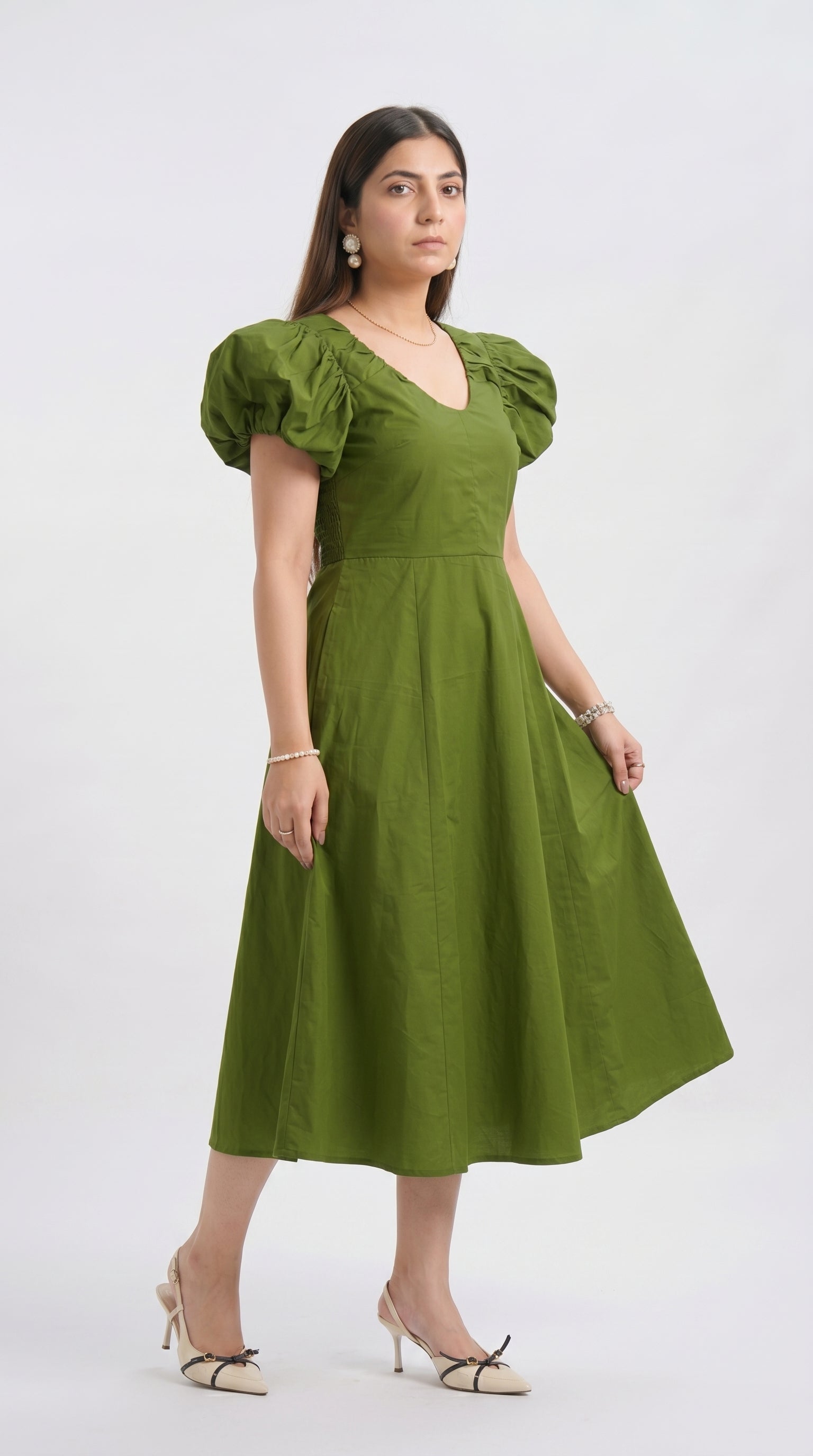 Woman wearing a green dress on a white background