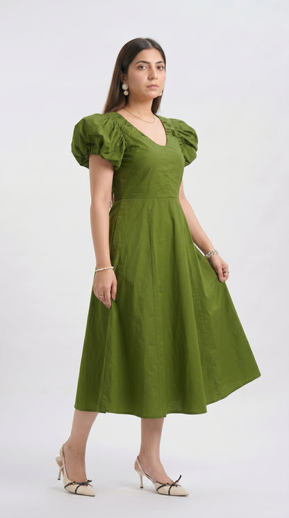 Woman wearing a green dress on a white background