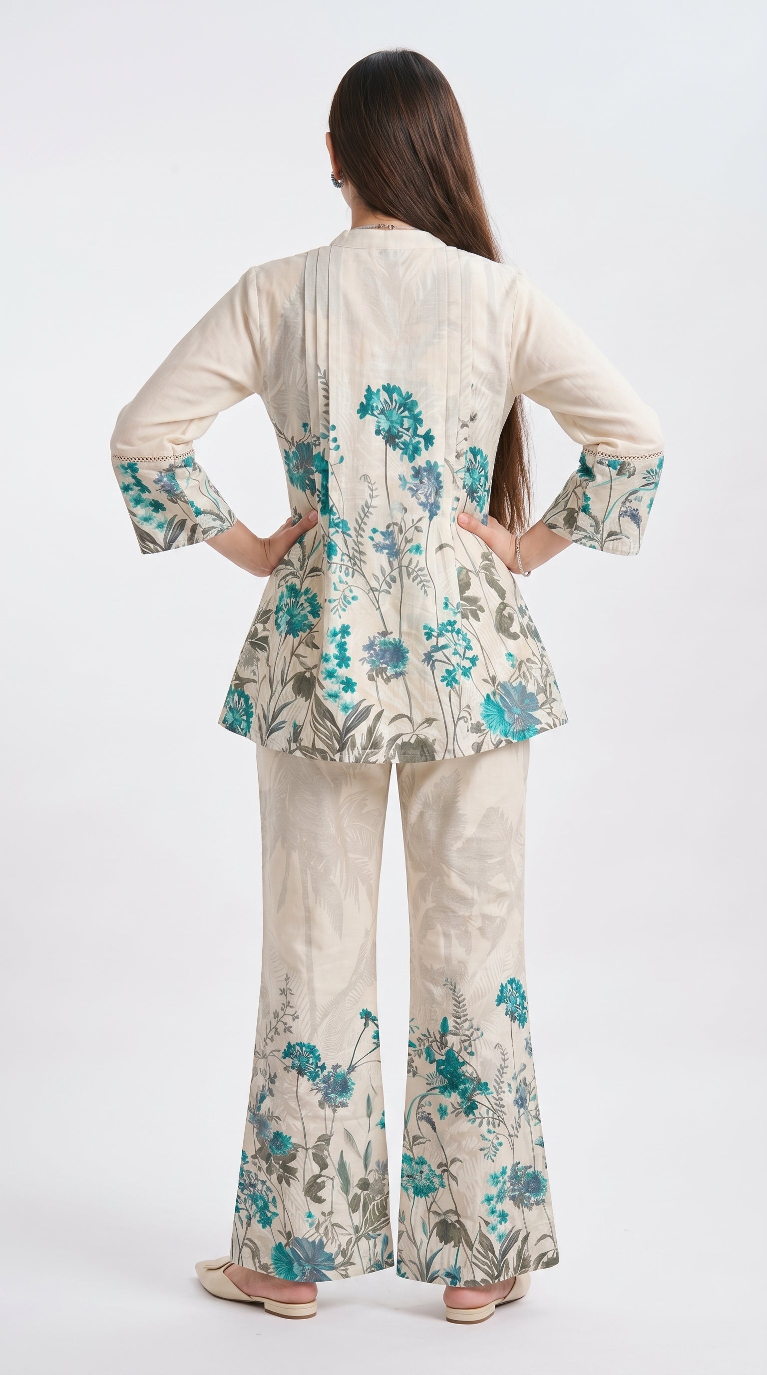 Woman wearing a floral outfit with a white background