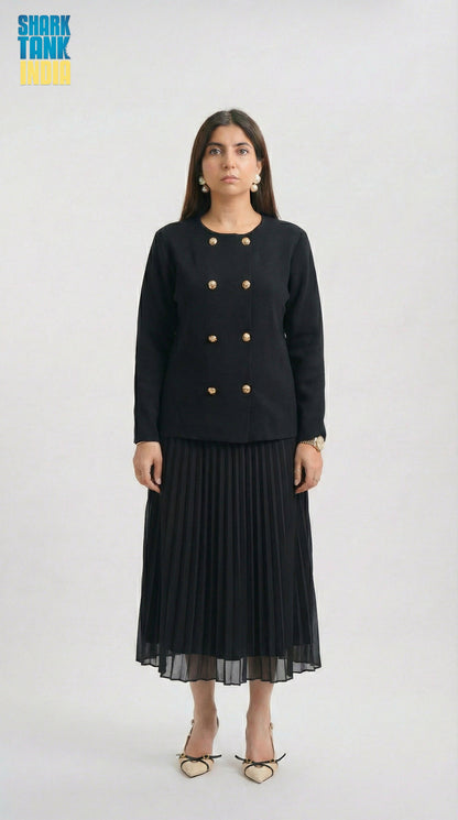 Woman wearing a black outfit with gold buttons on a white background