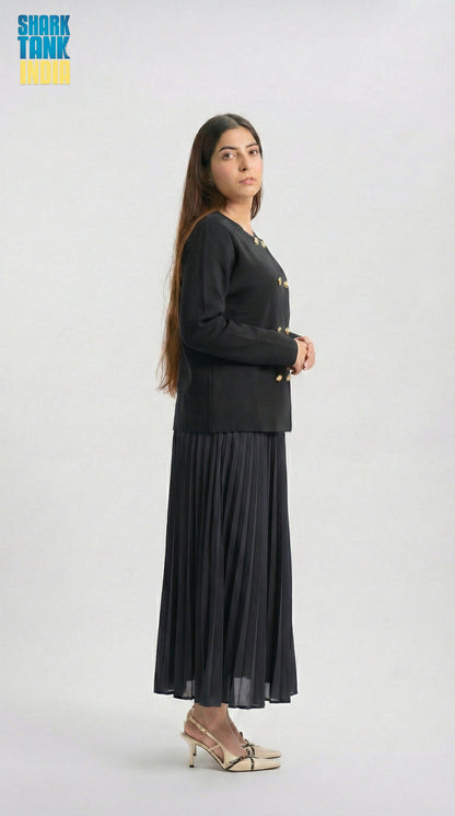 Woman wearing a black outfit with a long skirt on a white background