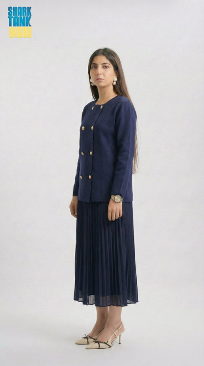 Woman wearing a navy blue suit with gold buttons on a white background