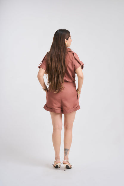 Woman wearing a pink outfit standing against a white background