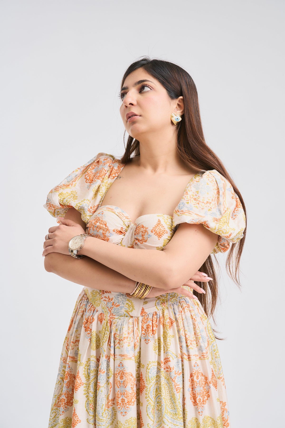 Woman wearing a floral dress against a plain background