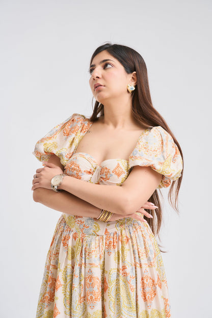 Woman wearing a floral dress against a plain background