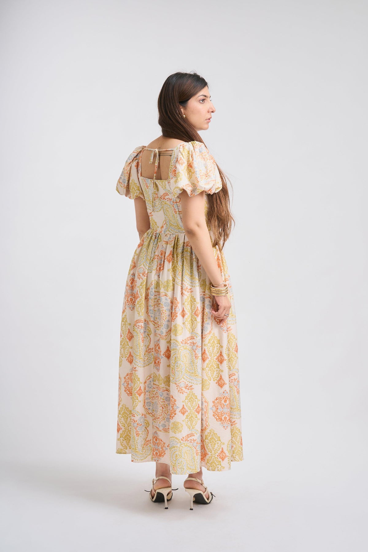 Woman wearing a floral dress on a white background