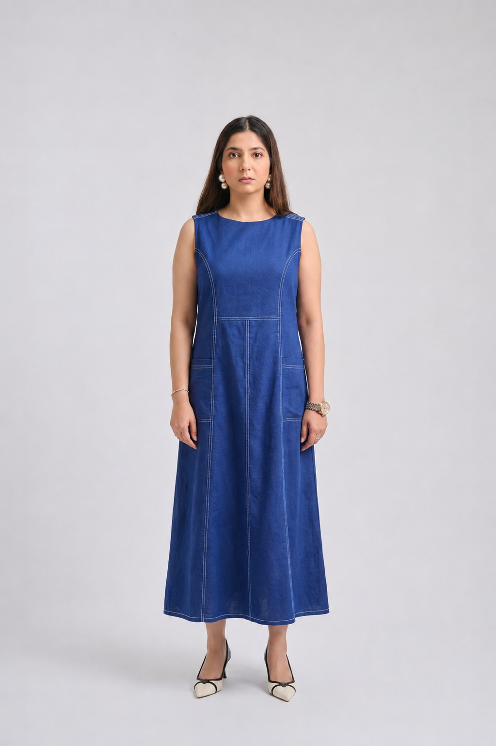 Woman wearing a blue dress on a light gray background
