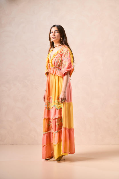 Woman wearing a colorful dress with a plain background