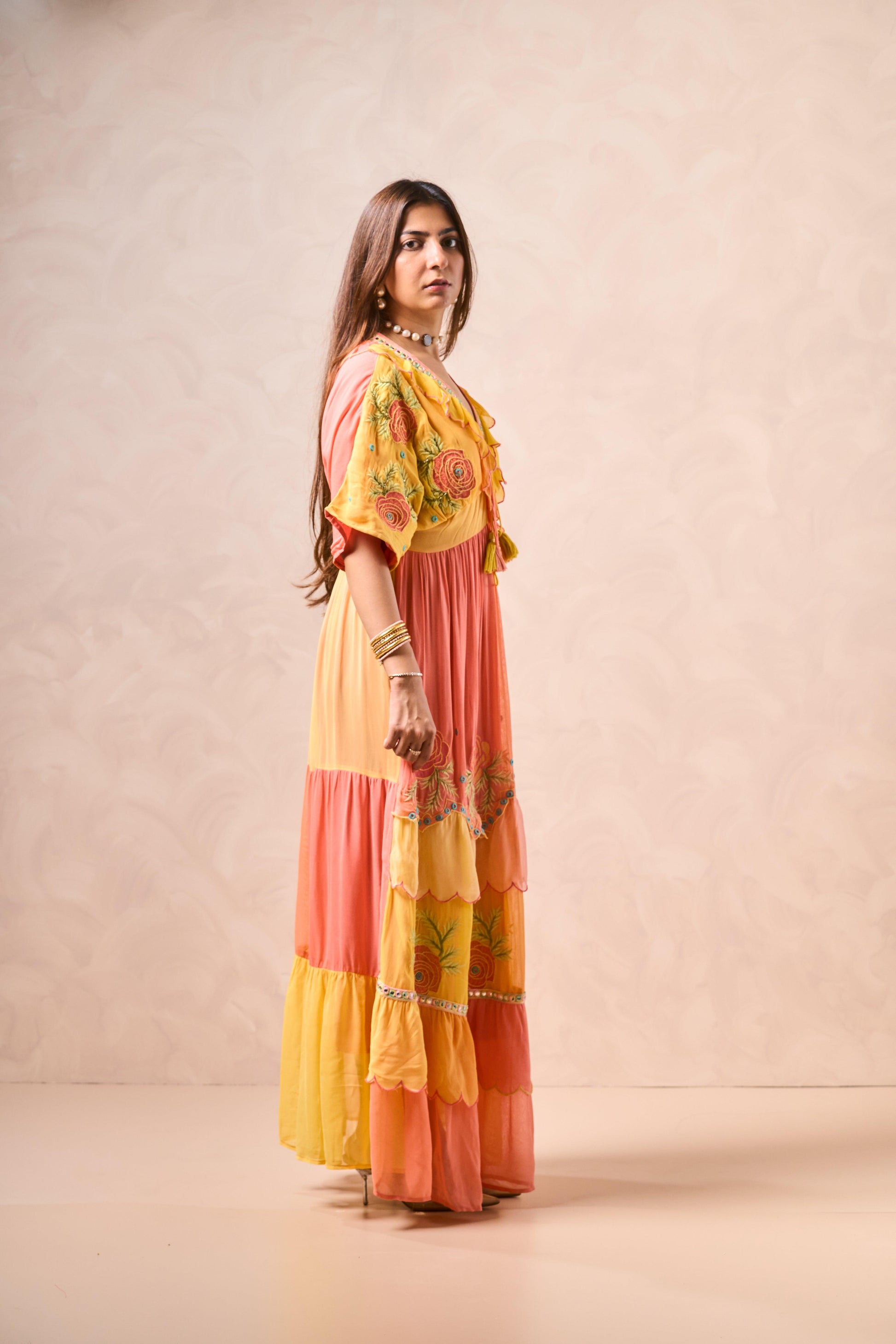 Woman wearing a colorful dress with a neutral background