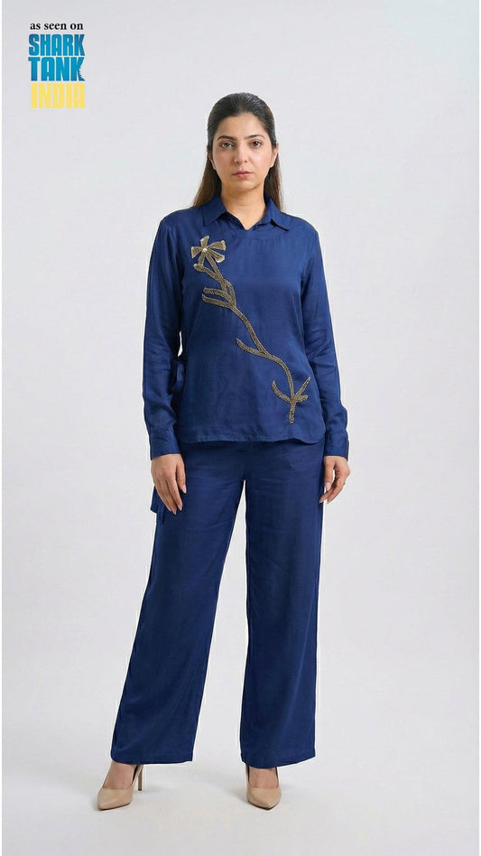 Woman wearing a blue outfit with a design on a white background