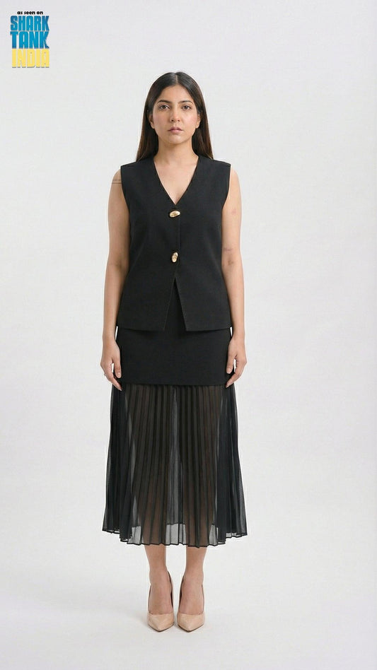 Woman wearing a black sleeveless top and pleated skirt on a white background