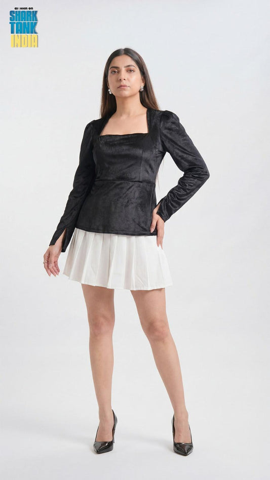 Woman wearing a black top and white skirt on a white background