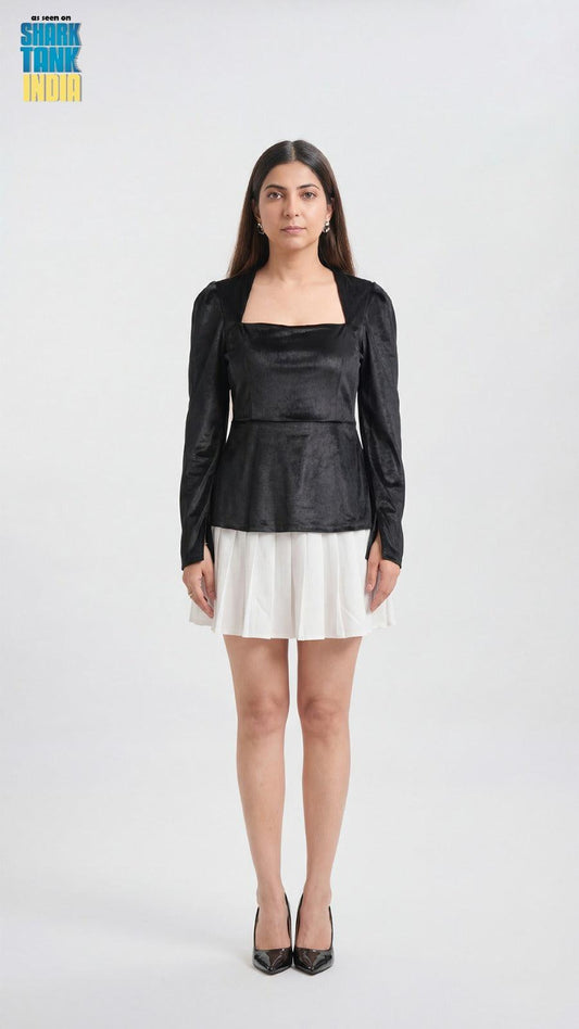 Woman wearing a black top and white skirt on a white background