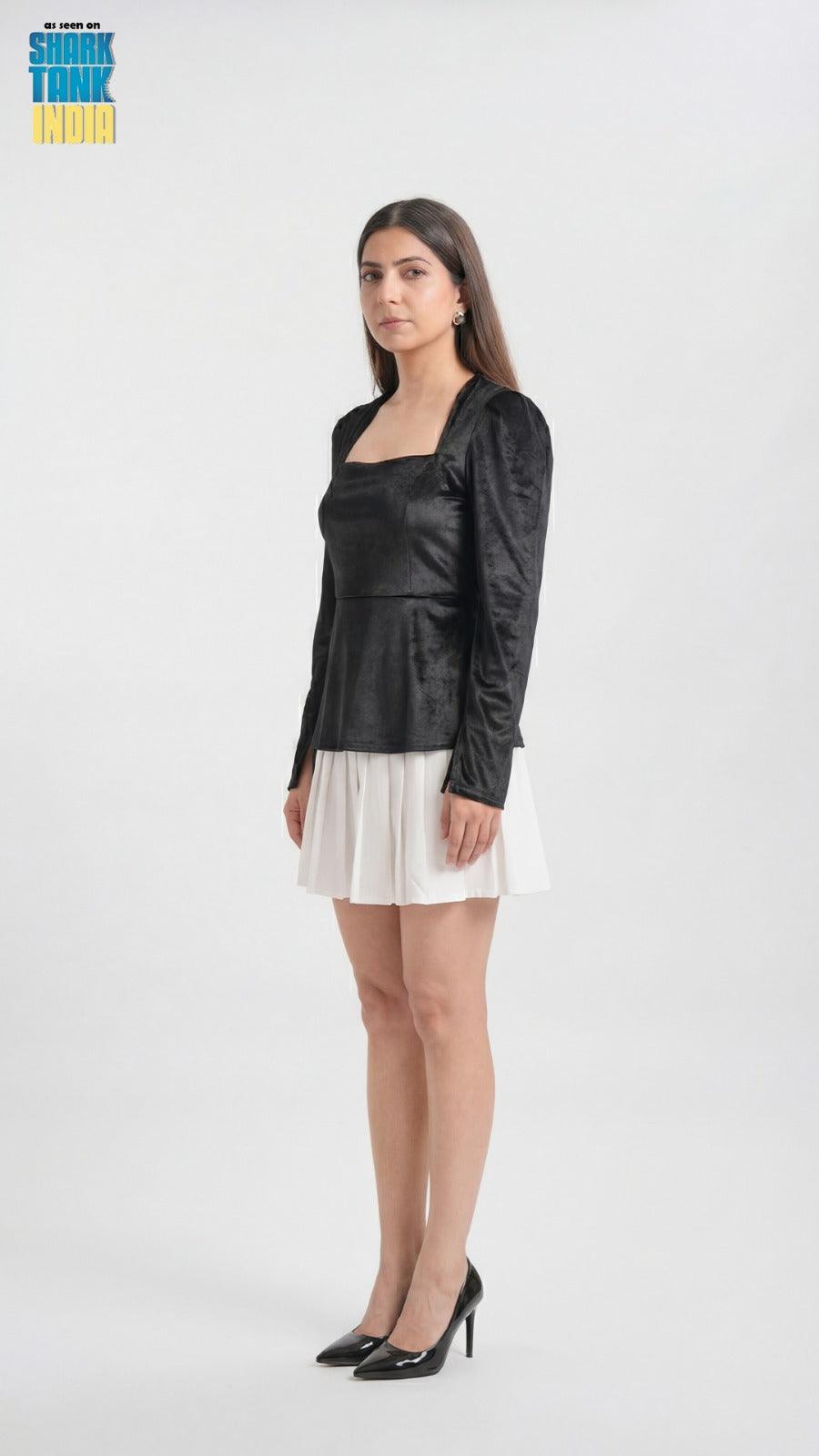 Woman wearing a black top and white skirt on a white background