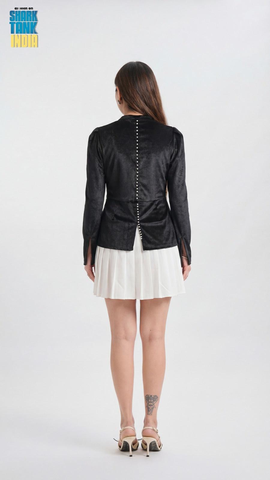 Woman wearing a black leather jacket and white skirt on a white background