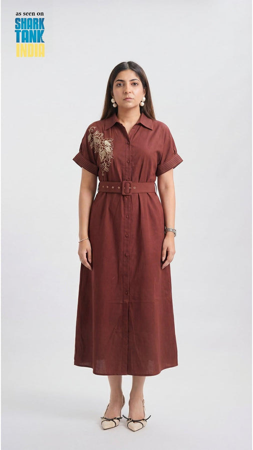 Woman wearing a brown dress with a belt on a white background