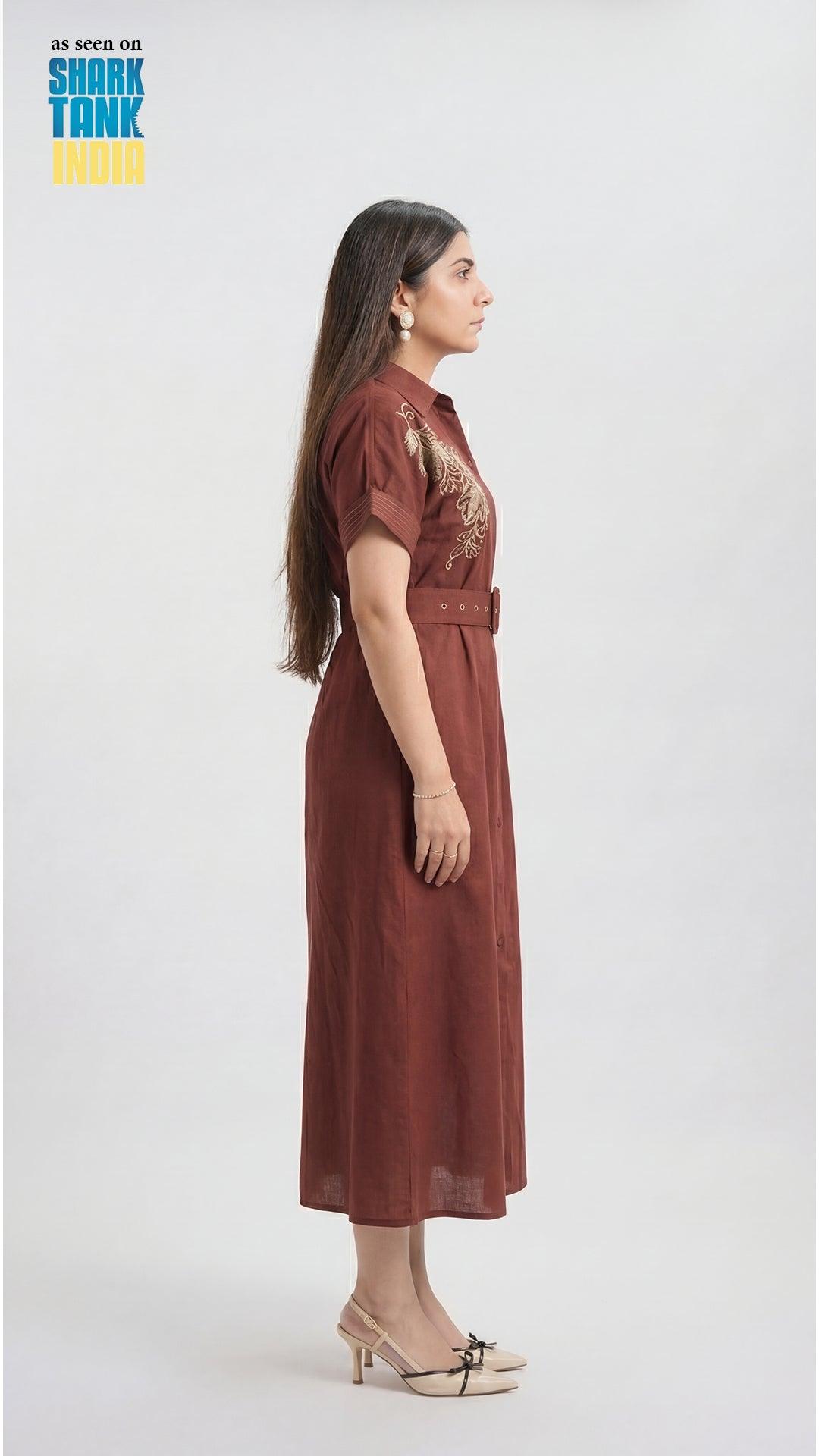 Woman wearing a brown dress with a belt on a white background, featuring 'Shark Tank' branding.