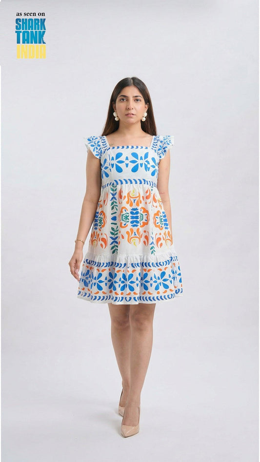 Woman wearing a colorful dress with floral patterns on a white background