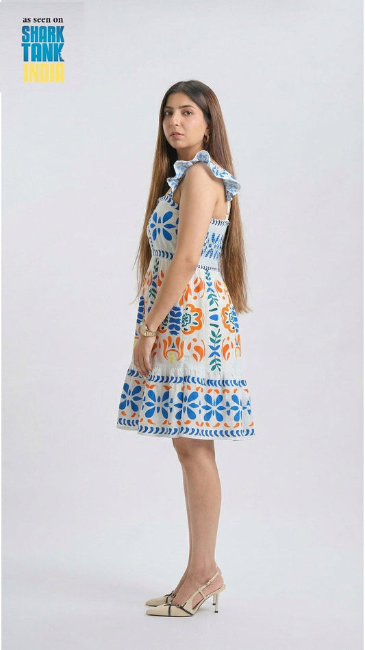 Woman wearing a colorful floral dress on a white background