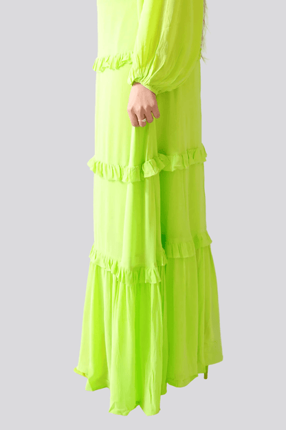 Green dress with ruffled layers on a white background