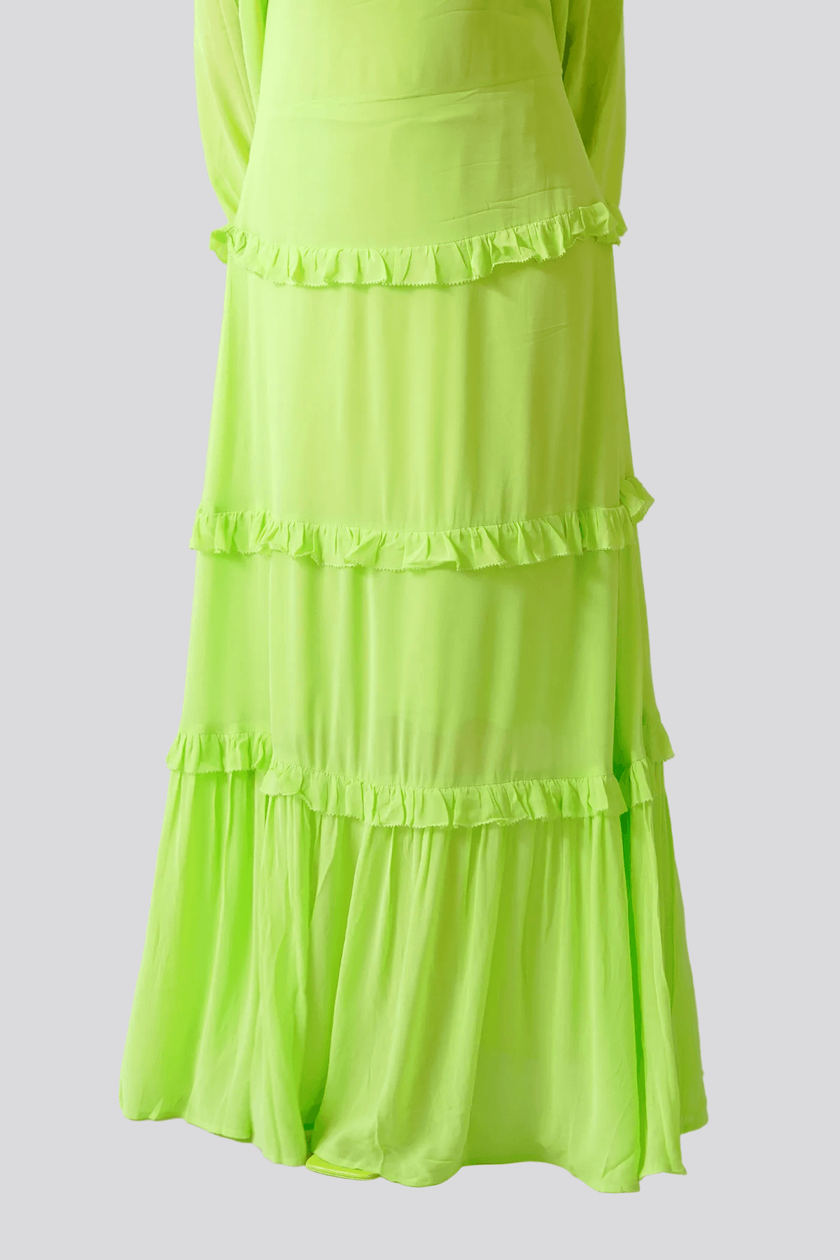 Neon green dress with ruffled layers on a white background