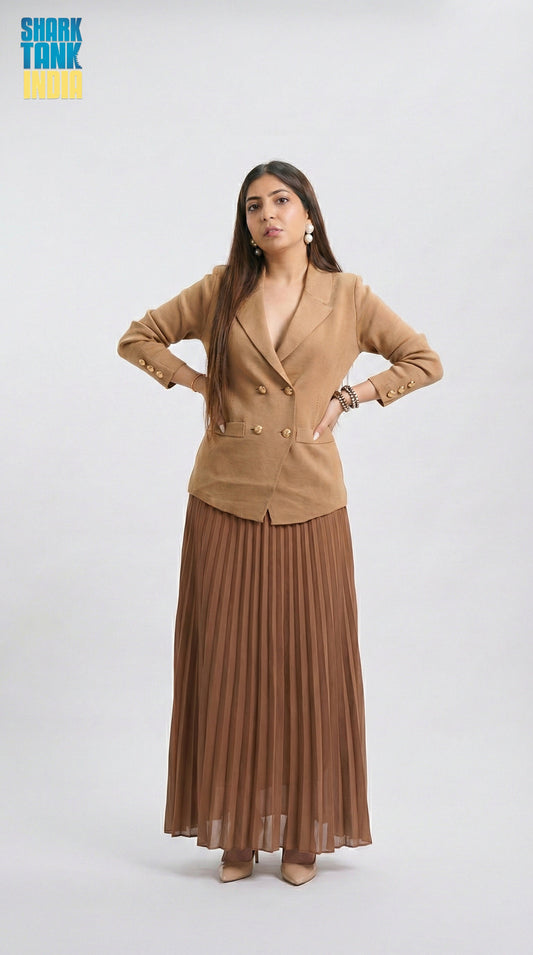 Woman wearing a brown blazer and pleated skirt on a white background