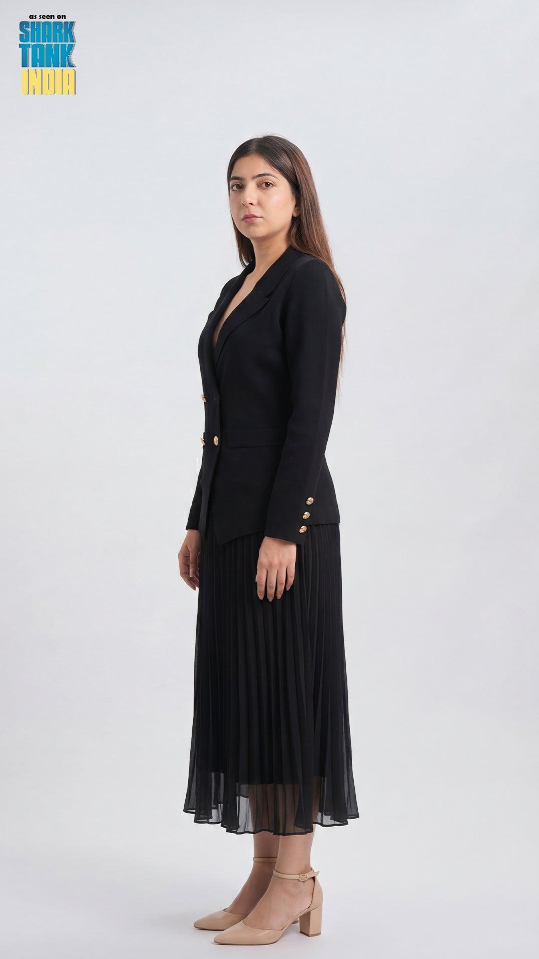 Woman wearing a black blazer and pleated skirt on a white background