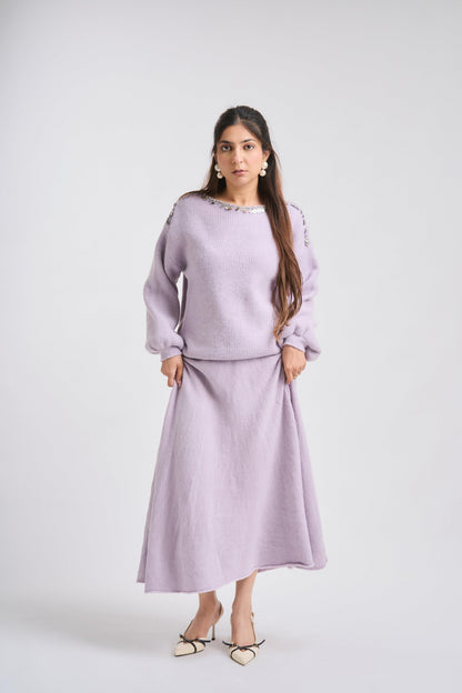 Woman wearing a light purple outfit on a white background