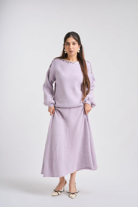 Woman wearing a light purple outfit on a white background