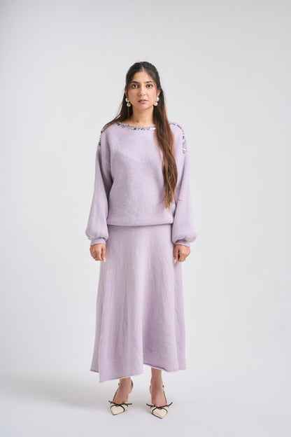 Woman wearing a light purple outfit on a white background