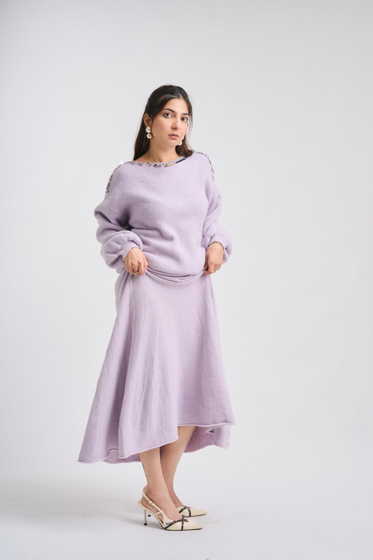 Woman wearing a light purple dress on a white background