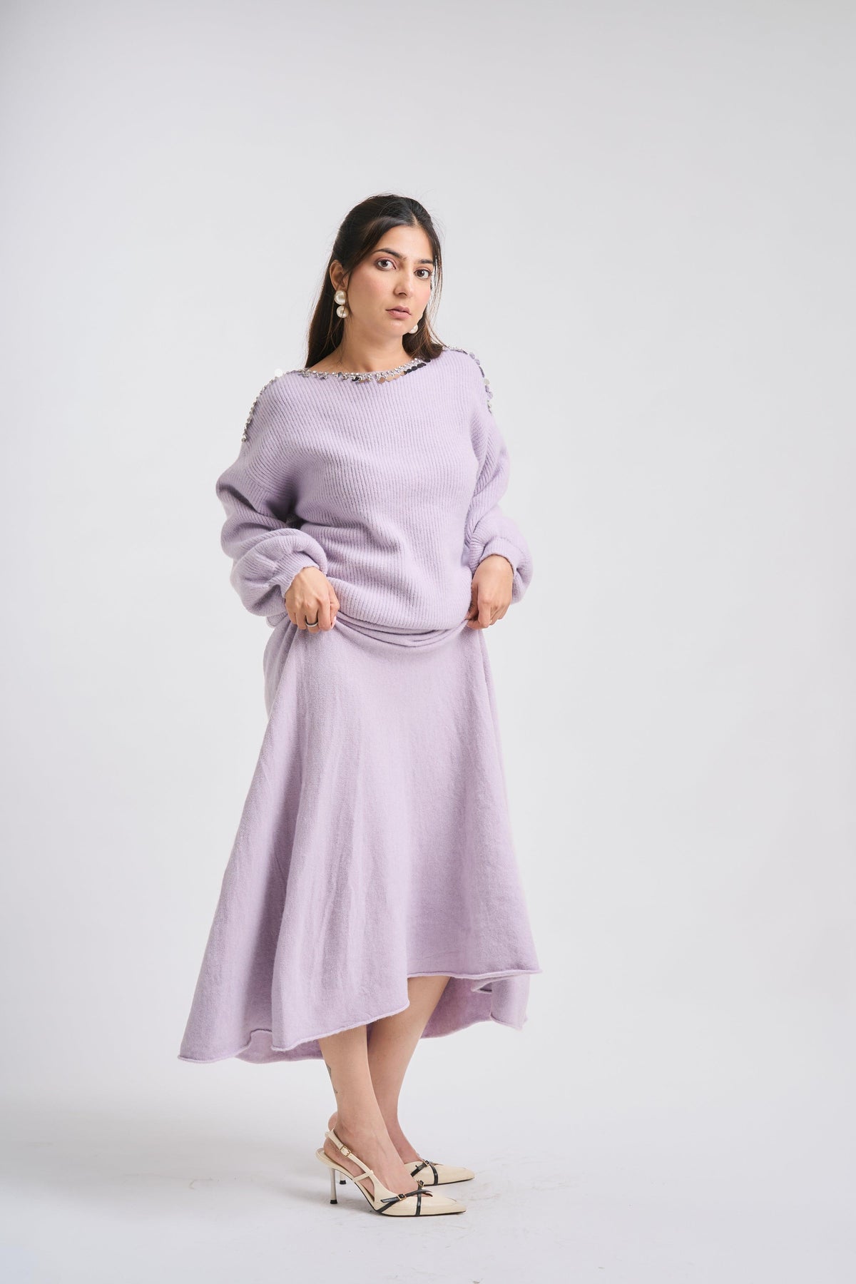 Woman wearing a light purple dress on a white background