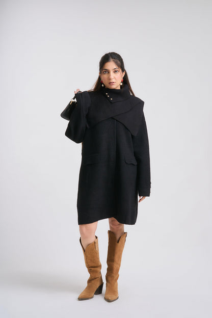 Woman wearing a black coat and brown boots on a white background