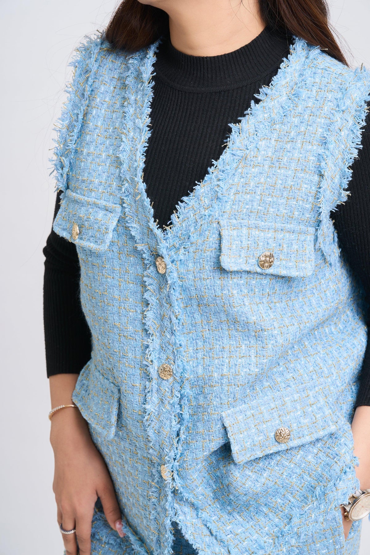 Light blue textured vest worn by a person on a white background