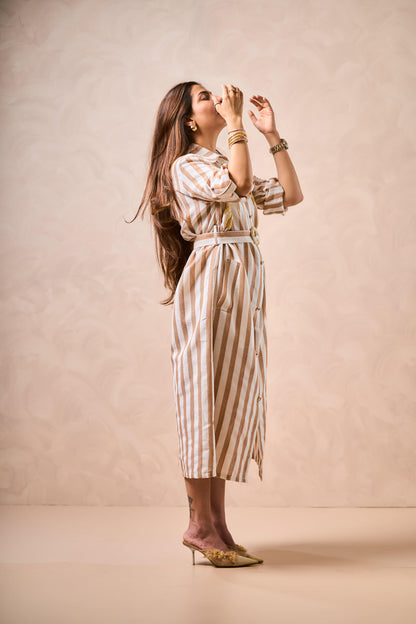 Woman wearing a striped dress against a beige background