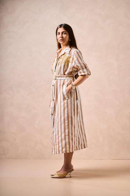 Woman wearing a striped dress against a beige background