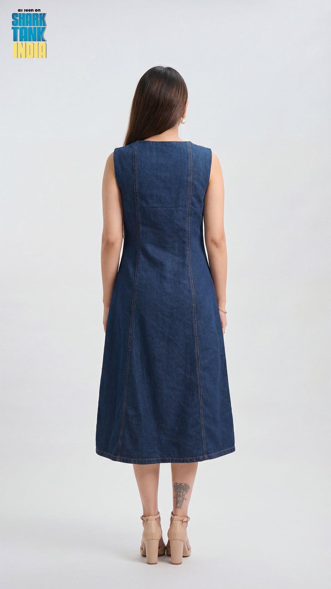 Woman wearing a blue denim dress against a white background