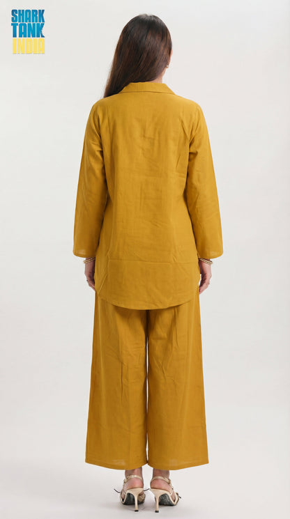 Person wearing a mustard yellow outfit on a white background