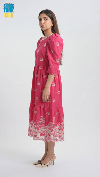 Woman wearing a pink floral dress on a white background