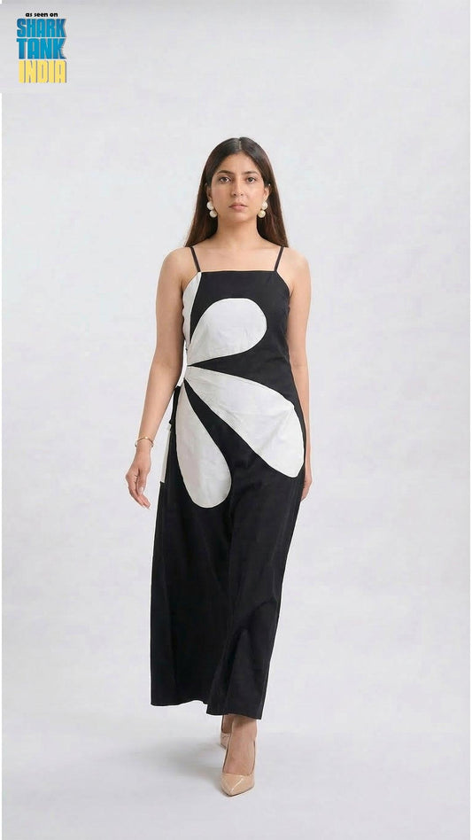 Woman wearing a black dress with a white floral design on a white background
