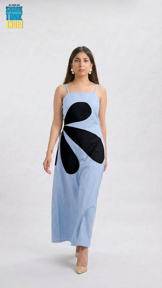 Woman wearing a light blue dress with black abstract design on a white background