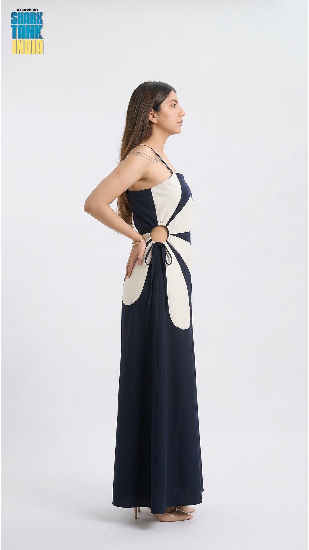 Woman wearing a black and white dress with cut-out design on a white background