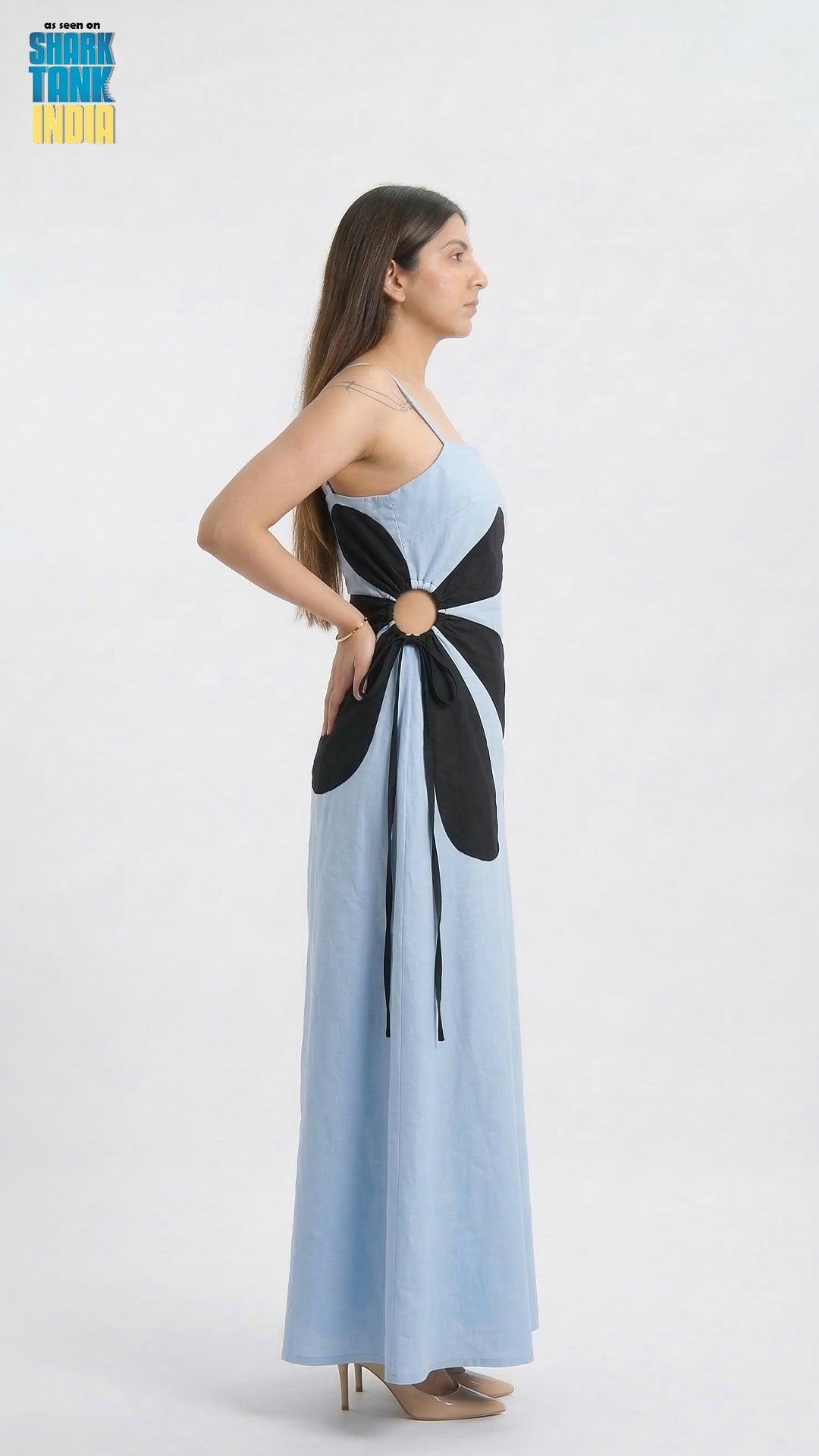Woman wearing a long dress with a black and white pattern on a white background