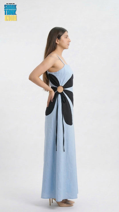 Woman wearing a long dress with a black and white pattern on a white background