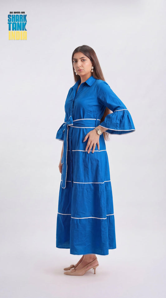 Woman wearing a blue dress with white stripes on a white background