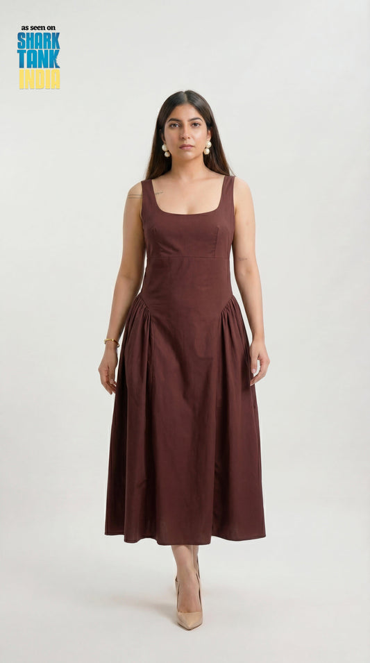 Woman wearing a brown dress on a white background with Shark Tank logo.