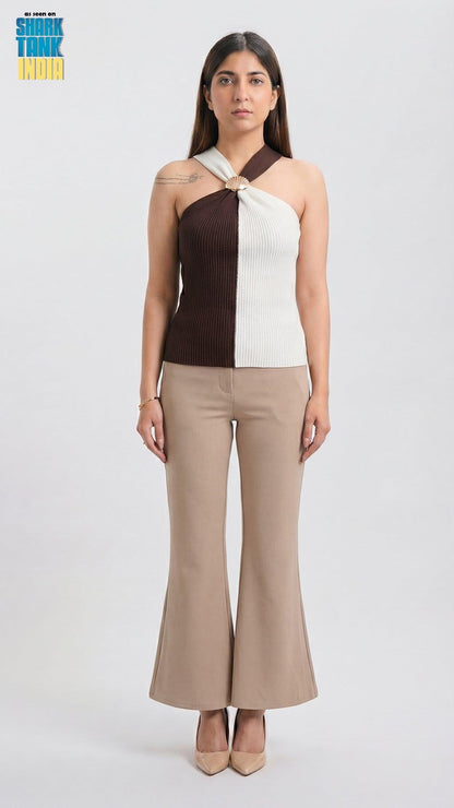 Woman wearing a two-tone top and beige pants on a white background