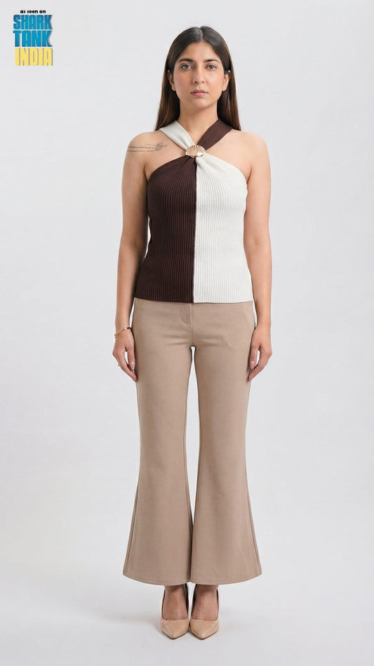 Woman wearing a two-tone top and beige pants on a white background